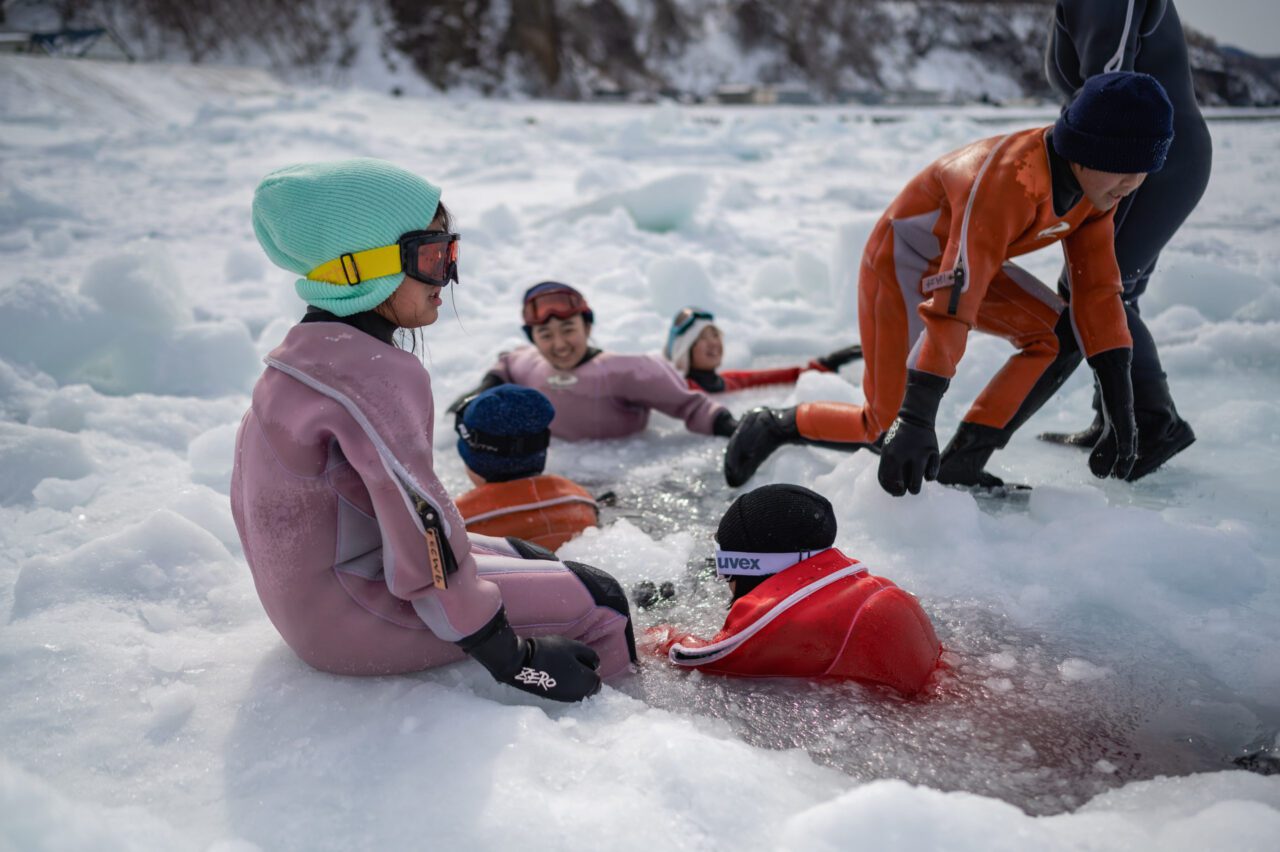 世界自然遺産・知床の流氷で遊ぶ小学生と中学生